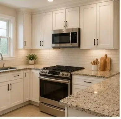 Bright white kitchen with granite countertops, stainless steel range and microwave, and a window over the sink.