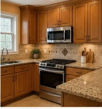 L-shaped kitchen with oak cabinets, granite countertops, and a stainless steel stove and microwave.